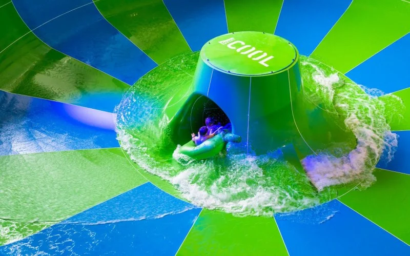 Riders inside the green and blue Supercrater bowl at Aqualand Moravia