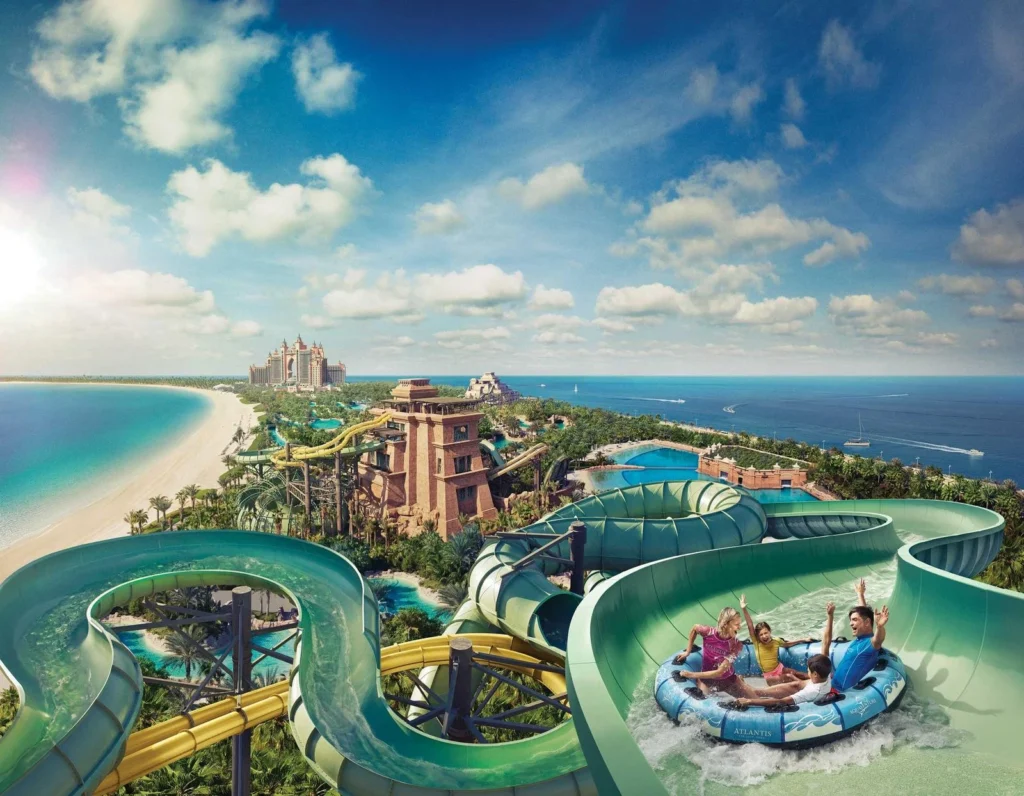 Guests on a raft slide overlooking Aquaventure Waterpark in Dubai