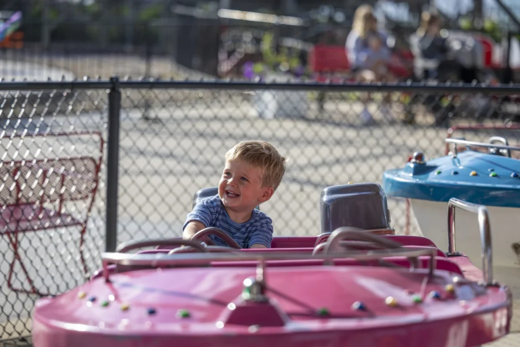 A child riding bumper cars at Arnolds Park Amusement Park