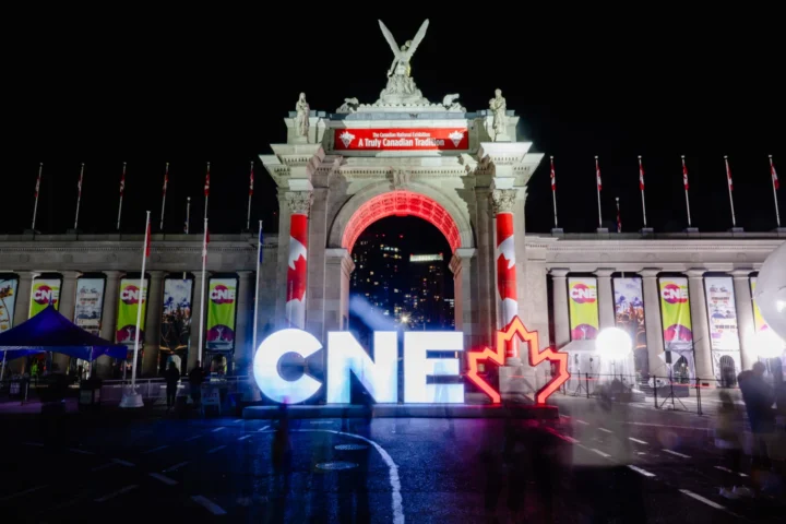 CNE sign illuminated at night at Exhibition Place in Toronto