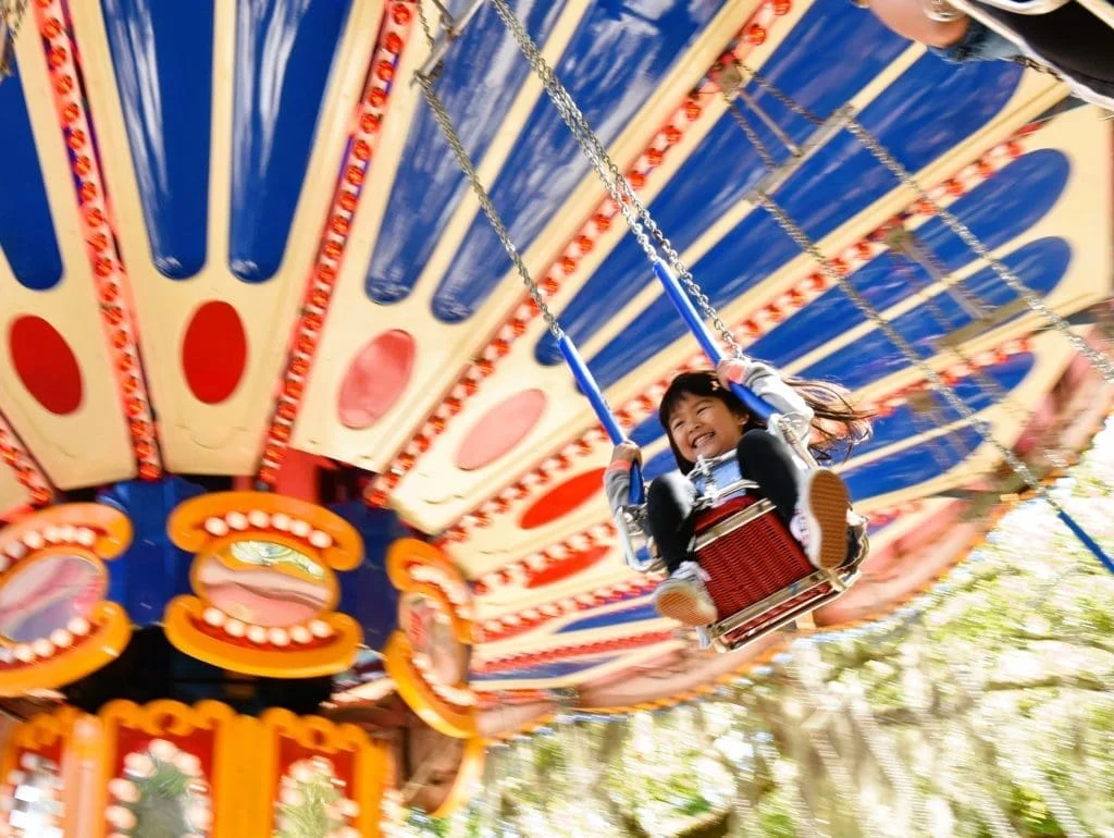 Guests on the chair swings at Carousel Gardens Amusement Park