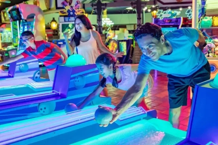 Family playing skeeball in Castle Park’s arcade in Riverside