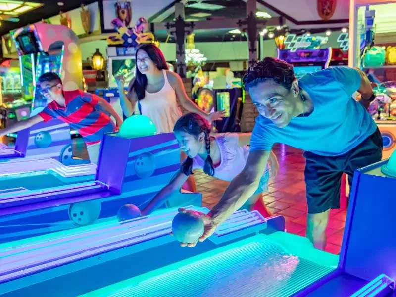 Family playing skeeball in Castle Park’s arcade in Riverside