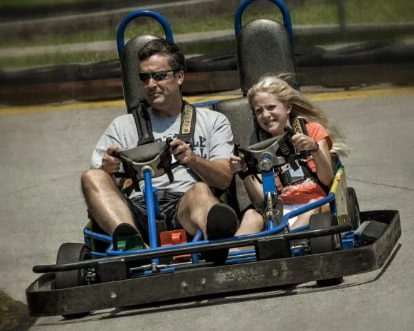 Father and daughter riding a go-kart at Celebration Station Greensboro