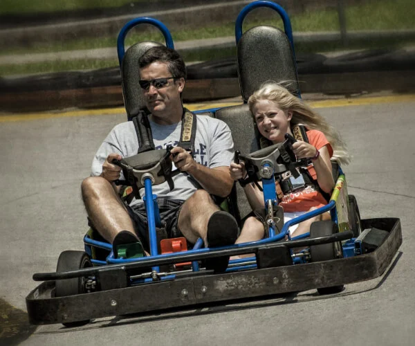 Father and daughter riding a go-kart at Celebration Station Greensboro