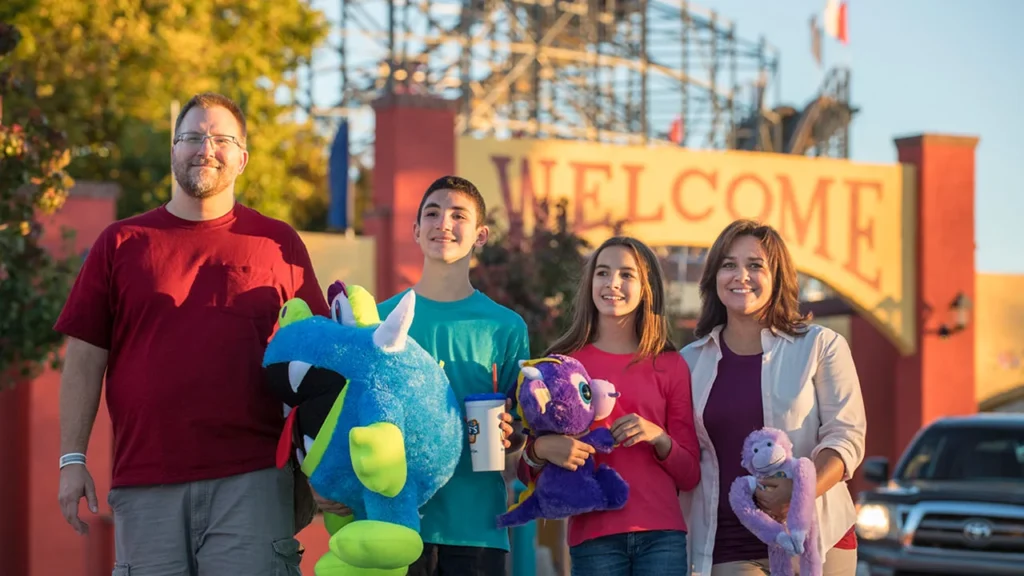 Family holding prizes at Cliff’s Amusement Park