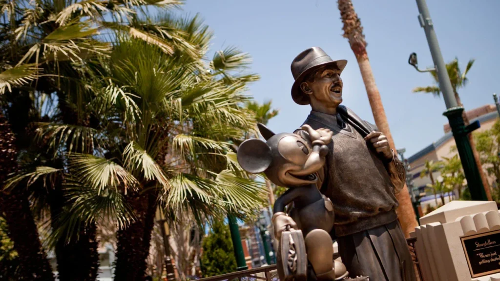 The bronze Storytellers statue of Walt Disney and Mickey Mouse stands on Buena Vista Street at Disney California Adventure.