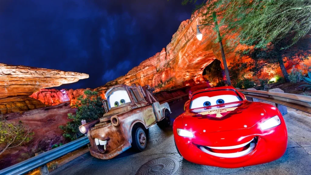 Lightning McQueen and Mater beside the red-rock scenery of Cars Land at Disney California Adventure.