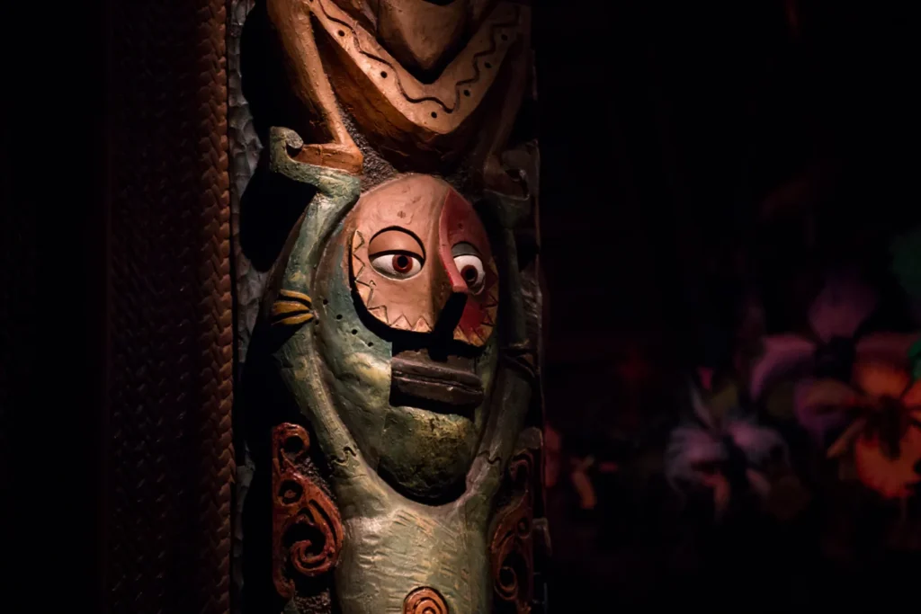 A carved face with an open mouth on a wooden figure inside the Enchanted Tiki Room in 2016.