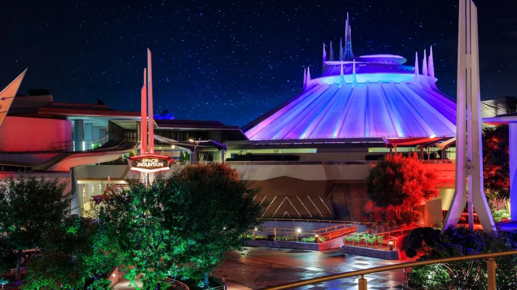 Space Mountain’s white building glows after dark in Tomorrowland at Disneyland Park.