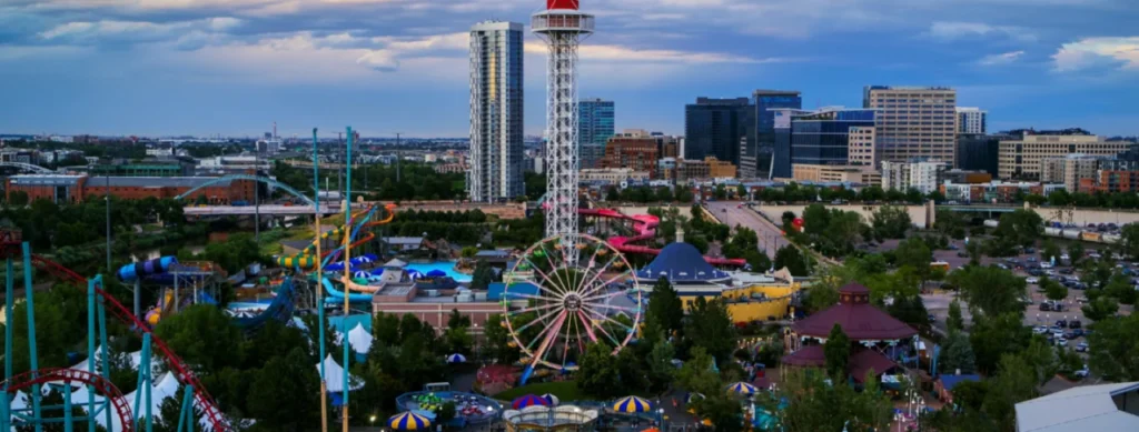 Rides and city skyline at Elitch Gardens in Denver