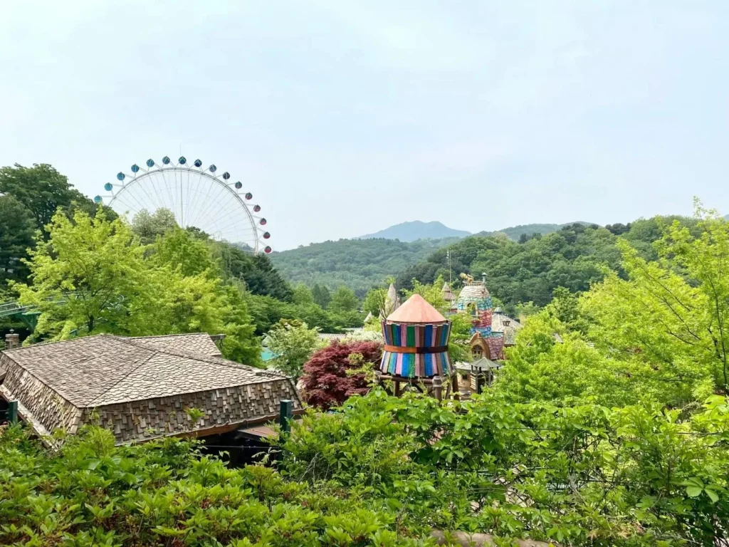 Gardens and colorful park buildings among trees at Everland in Yongin, South Korea