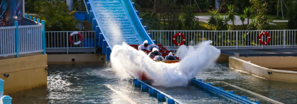 Riders splashing down a boat ride at Happy Valley Shenzhen