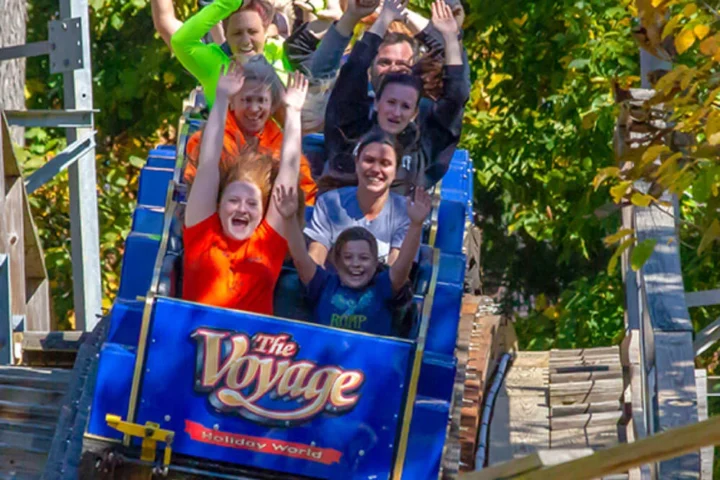 Guests riding The Voyage wooden roller coaster at Holiday World