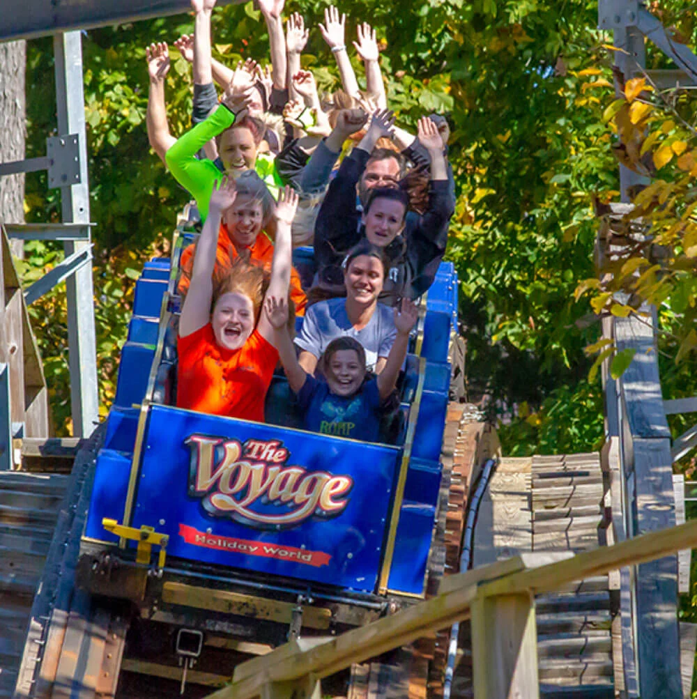 Guests riding The Voyage wooden roller coaster at Holiday World