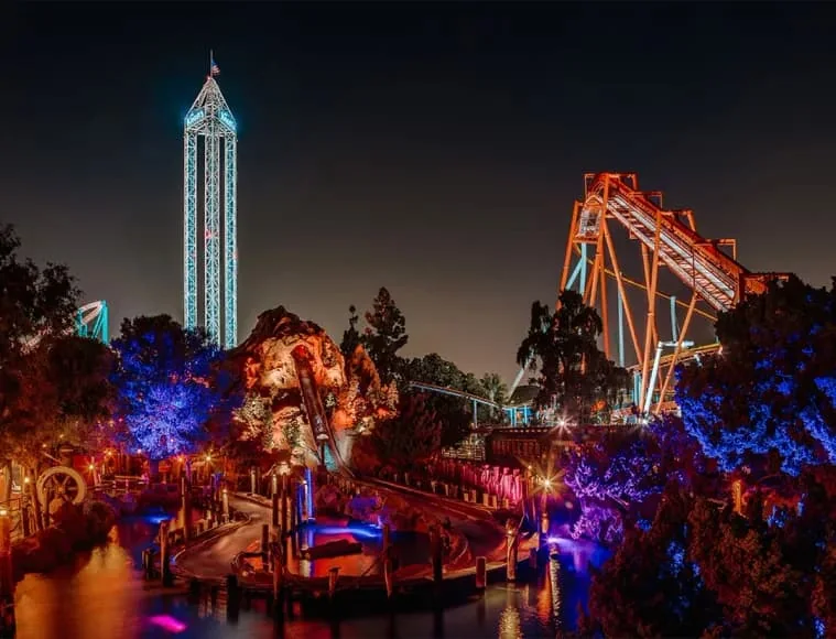 Illuminated rides rise over Knott’s Berry Farm after dark.