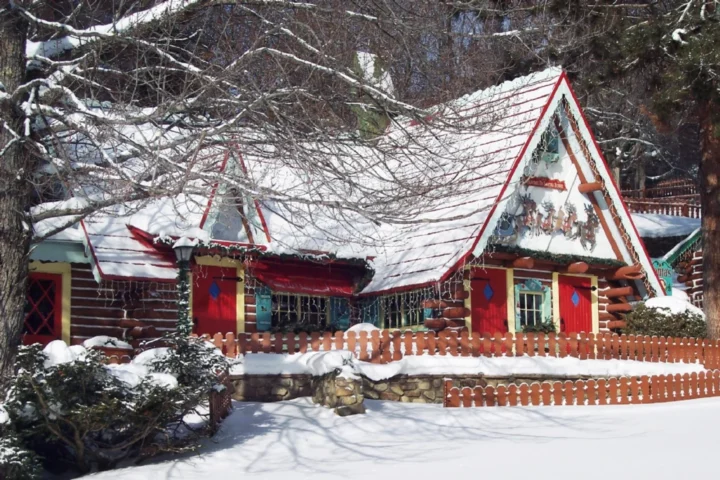 Santa and his house at Santa’s Workshop in North Pole, New York