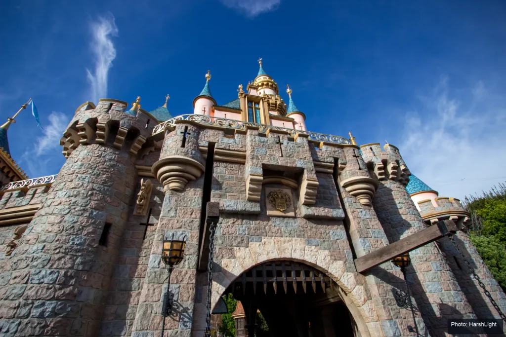 Sleeping Beauty Castle’s stone gateway and towers at Disneyland Park beneath a blue sky.