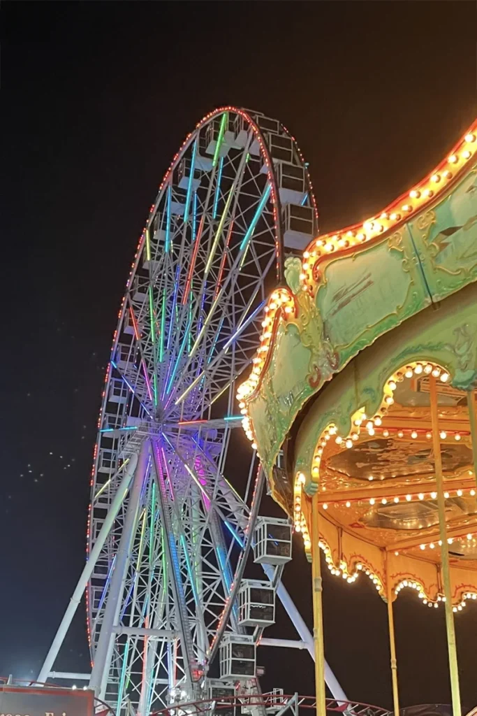 The Wheel and illuminated carousel at Steel Pier in Atlantic City at night