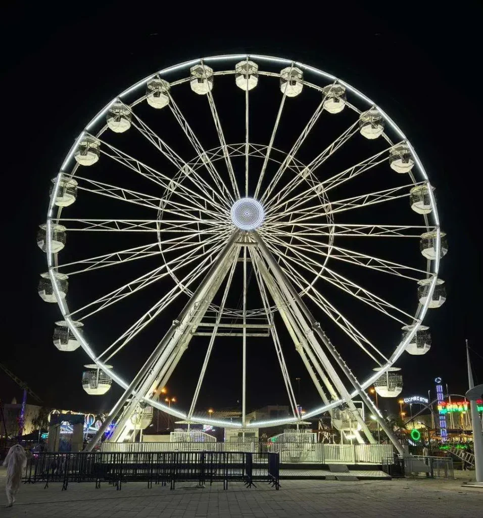 Ferris wheel illuminated at night at Winter Wonderland Kuwait